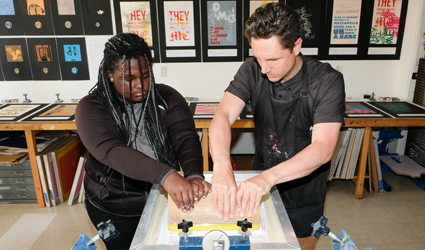 two students working on screen printing